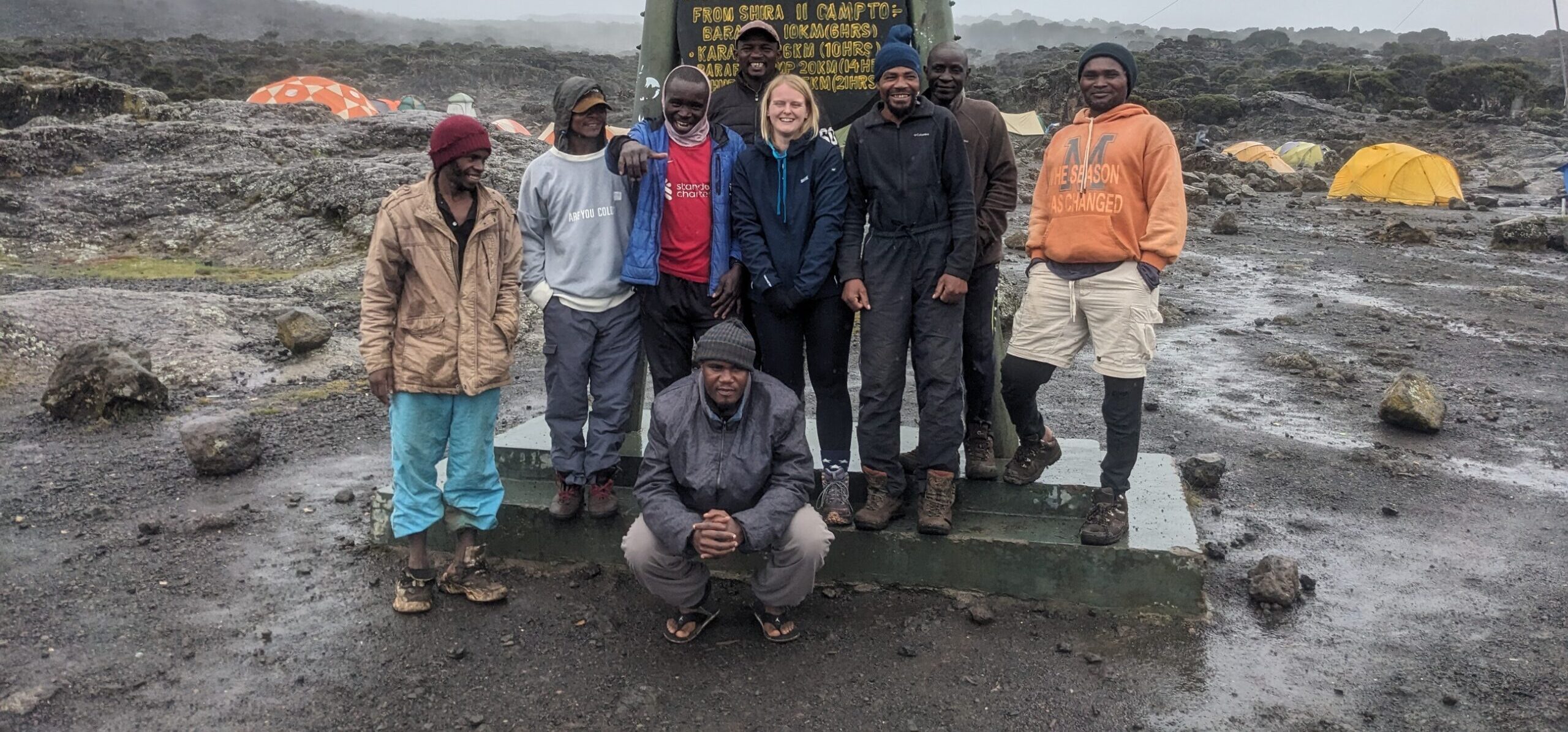 Climbers trekking on Mount Kilimanjaro high altitude trail with scenic landscape